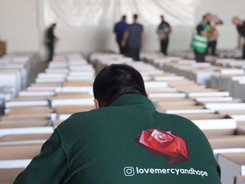 A volunteer packing aid under a Palestine Emergency banner in Egypt